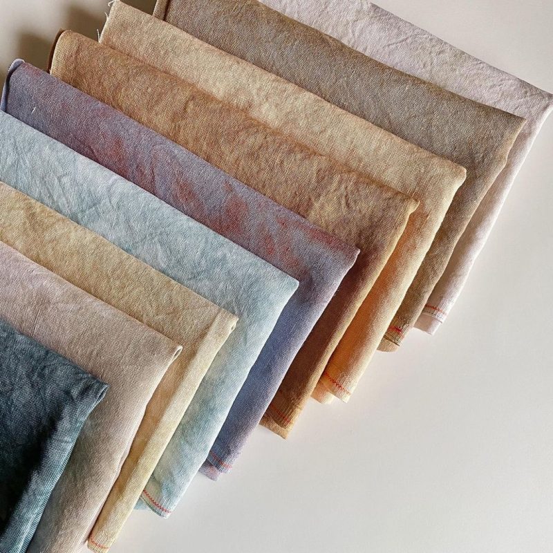A shot of naturally dyed fabrics, displaying luxurious drape, rich and soft texture.