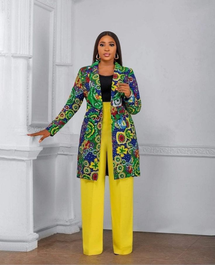 African woman in tailored corporate wear with subtle cultural detailing.
