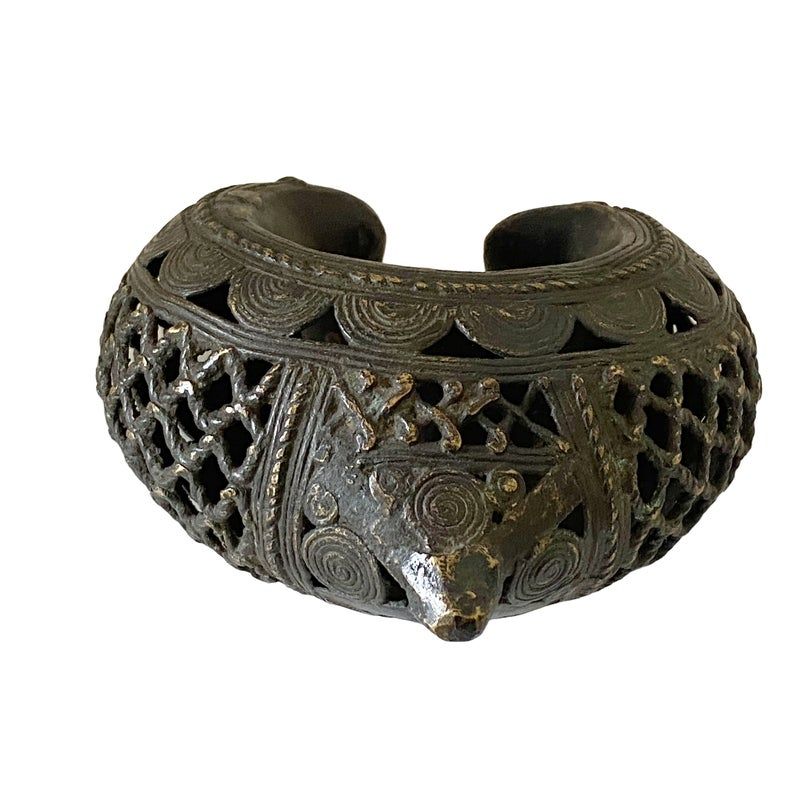 Detail of an elaborate Benin Bronze cuff, a piece of ancestral metalwork created using the sophisticated lost-wax casting technique.