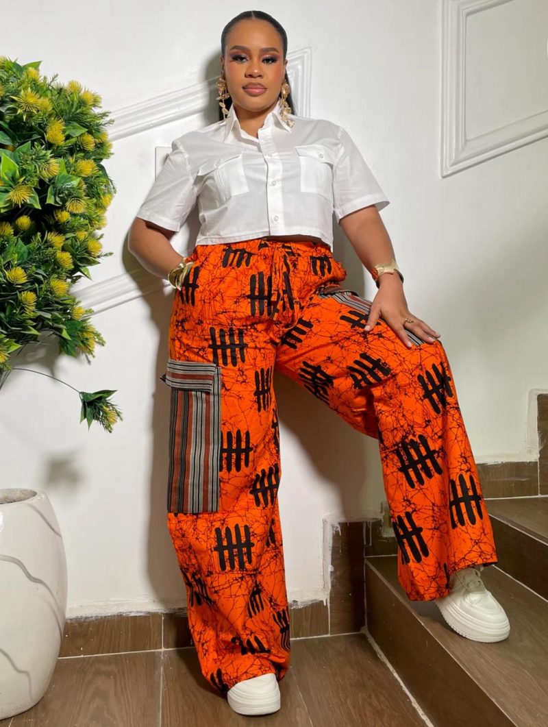 Chunky sneakers paired with Ankara trousers for Afro-street style