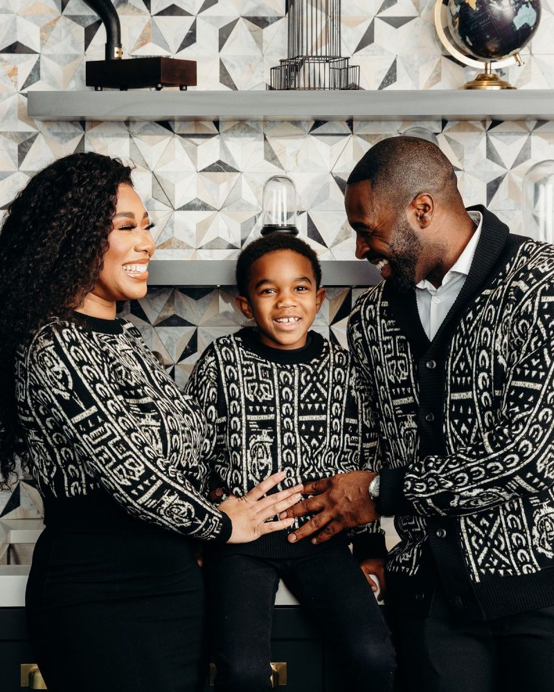 African family in quiet luxury outfits featuring Aso-Oke, Adire, and Northern cotton kaftan