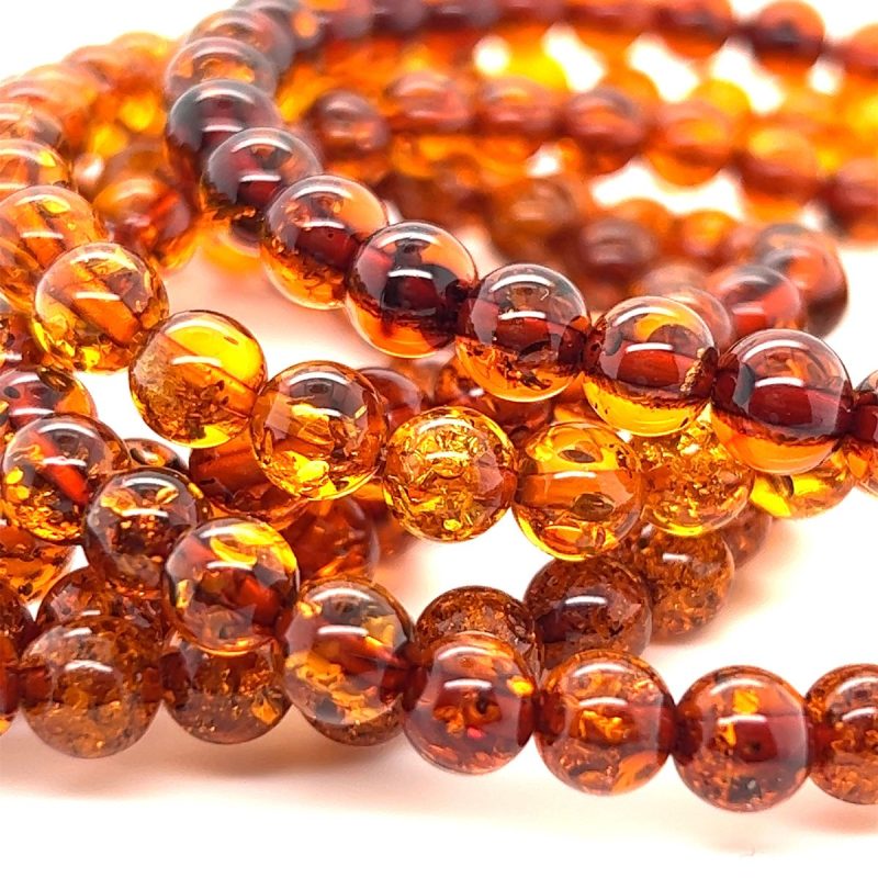 Raw, unrefined amber beads and other natural materials are used for sustainable African jewellery production, emphasising ethical sourcing.