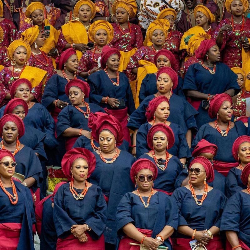 African women showcasing vibrant heritage fabrics in everyday street style.
