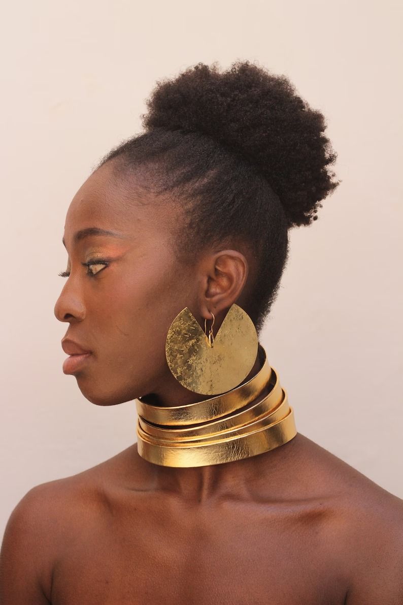 An African woman in brass statement hoops.