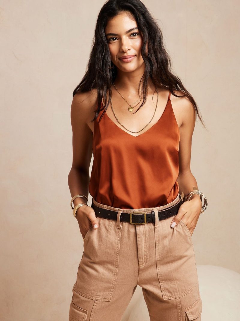 Neutral satin camisole and tailored trousers as refined wardrobe essentials