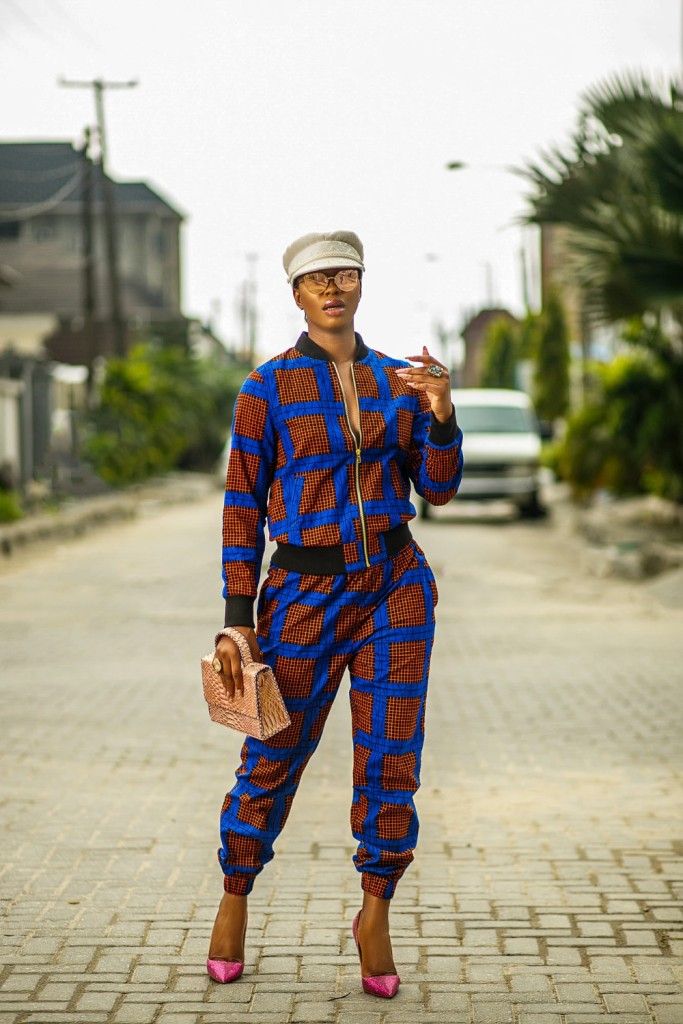An African woman styling a tracksuit with heels on a city street