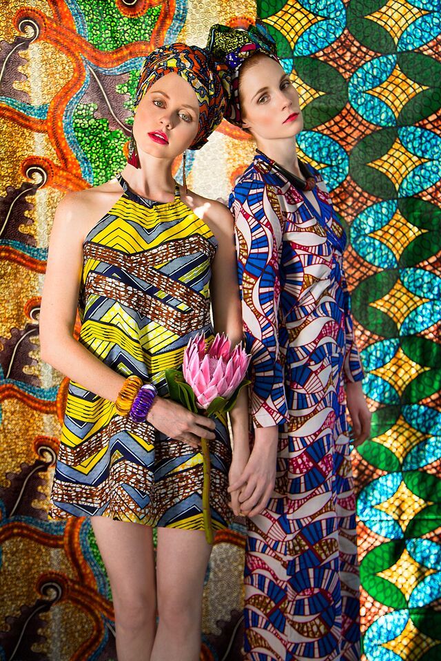 Models wearing a tailored African print, a culturally rooted garment, symbolising cultural assertion and the promotion of plural modernity by diaspora design hubs.
