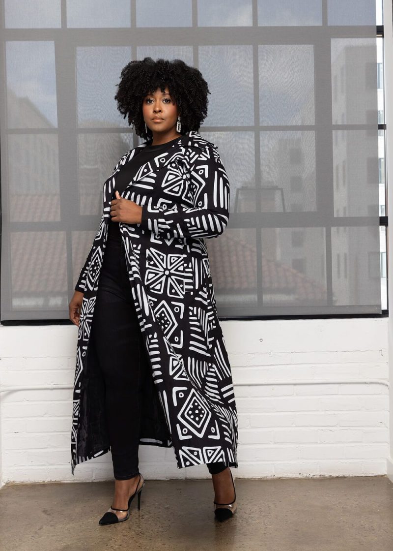 A tailored trench coat blending Western tailoring with Culturally-Rooted fabrics, illustrating the Afropolitan Aesthetic and Ancestral Knowledge in Diaspora Design Hubs.
