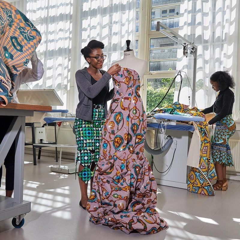 Modern design studio showcasing ethical local production and artisanal sovereignty, proving the investibility and traceability of African luxury brands.