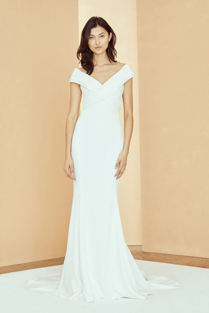 A minimalist off-the-shoulder cap sleeve criss-cross bodice modern bridal gown by Amsale 