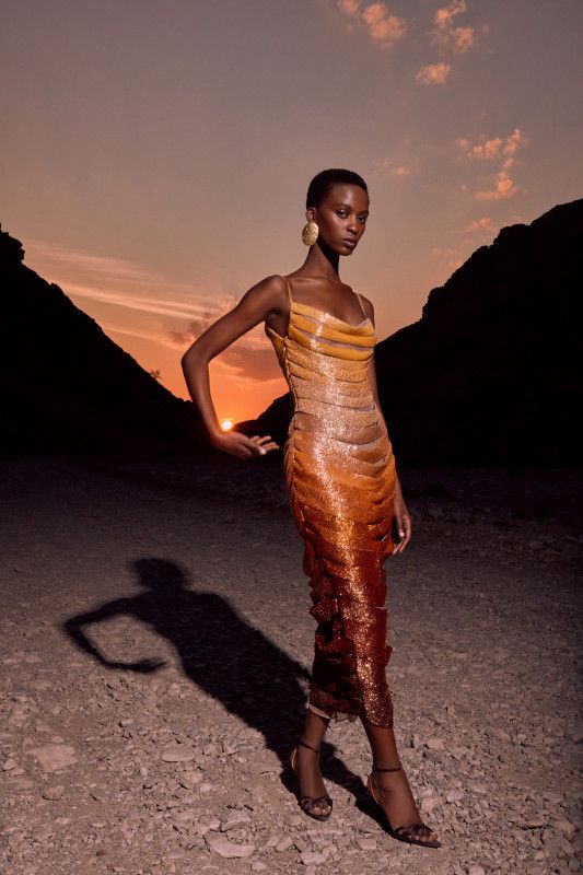 A 2026 luxury Liquid Silhouette gown in high-shine molten gold
