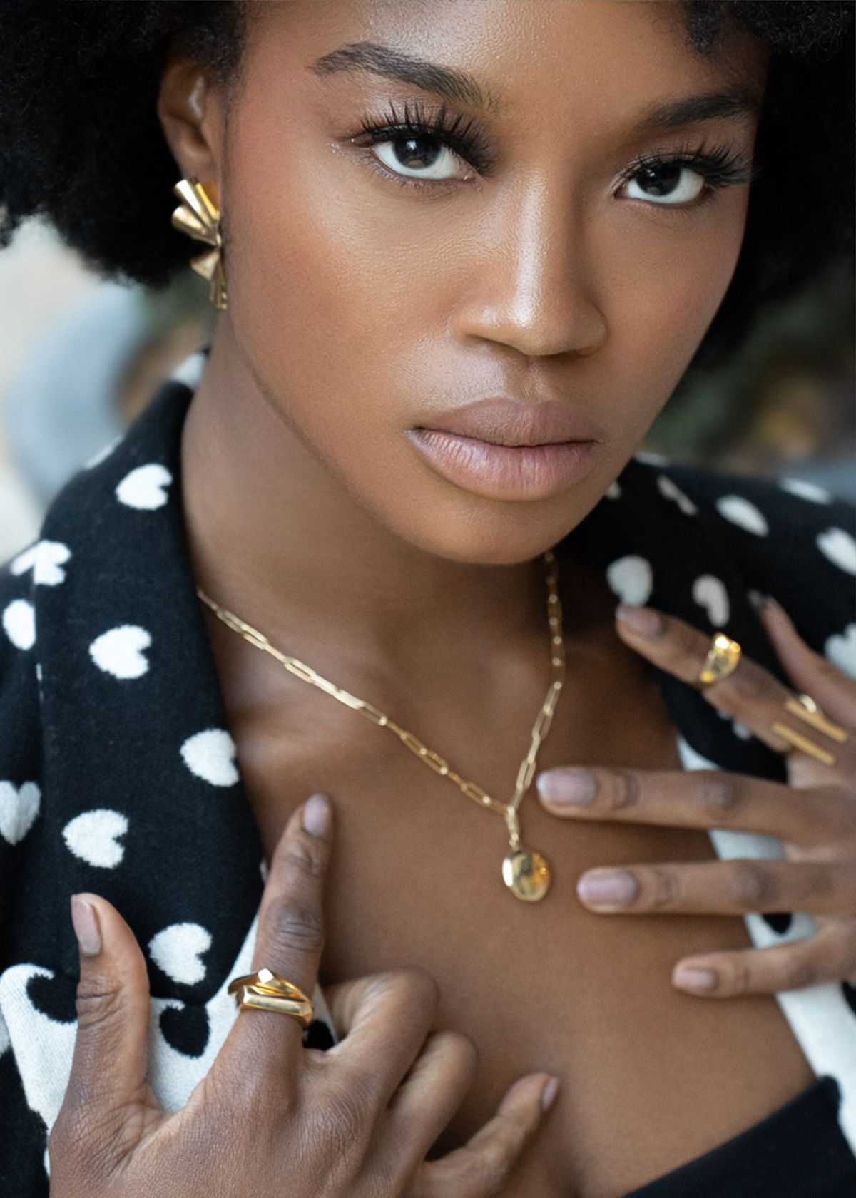 A shot of a woman wearing Bidu Fanned Earrings by Soko