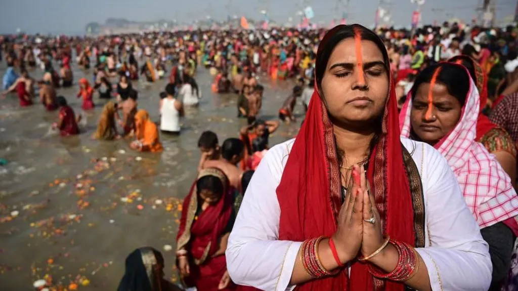 Kumbh Mela pilgrim seeking spiritual purification through ritual bathing at the confluence of a sacred river confluence
