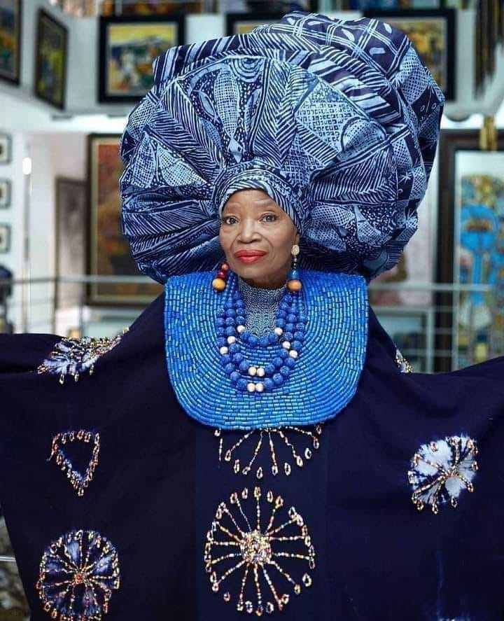 A photograph depicting a renowned Nigerian artist upholding Nigerian culture.