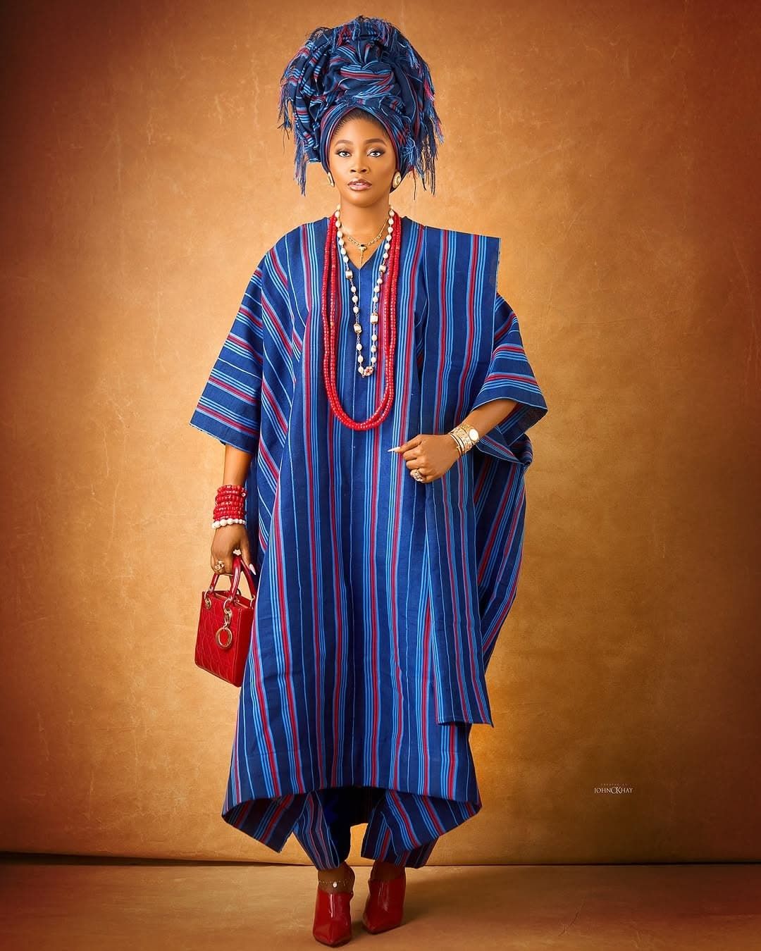 A picture of a young African woman wearing a traditional headwrap. Showing grandmother’s headwrap wove a legacy of culture, identity, and generational pride.