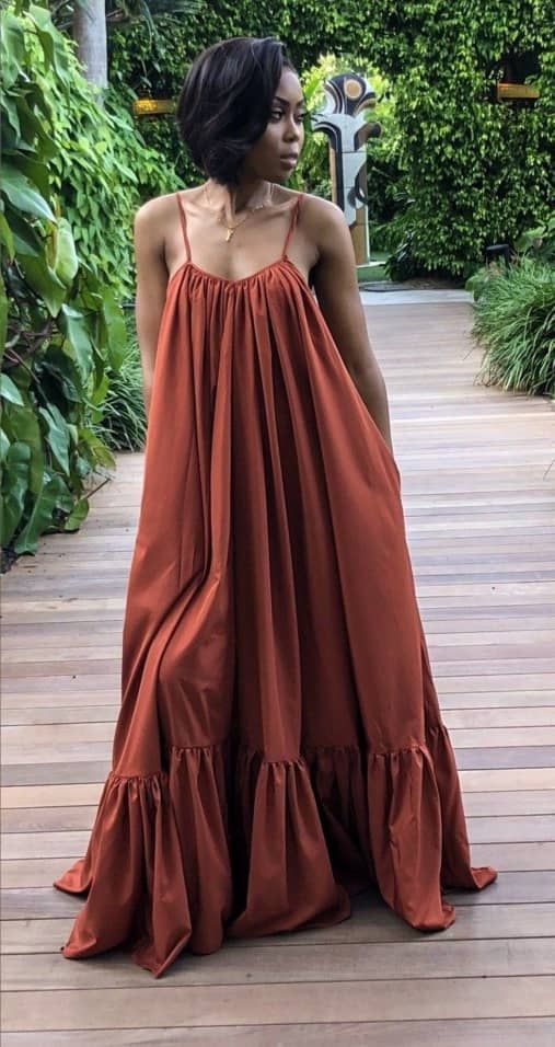 An inclusive woman in a high-end dress, representing the visionary fusion of visibility and belonging.