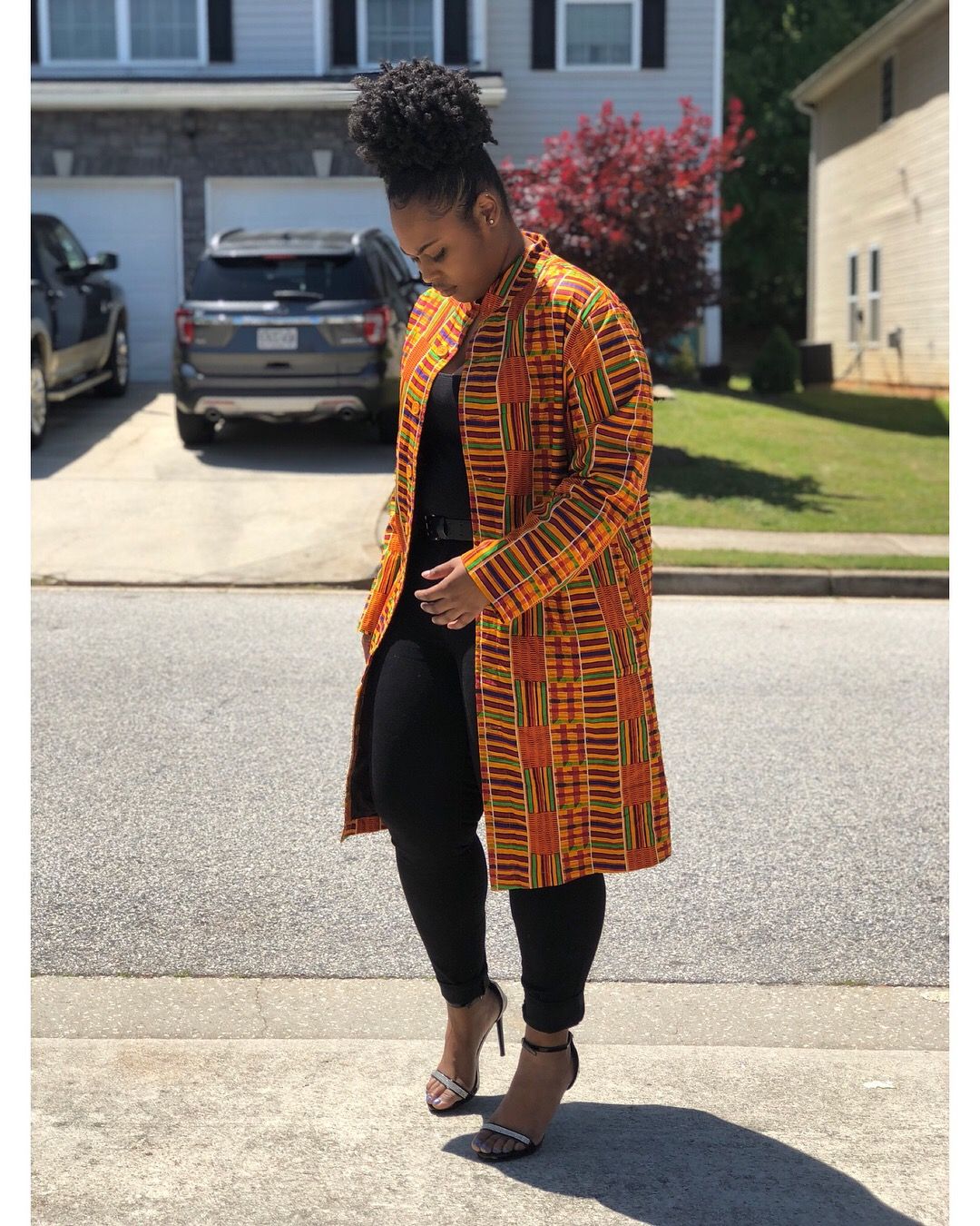 An inclusive woman in a Kente blazer.
