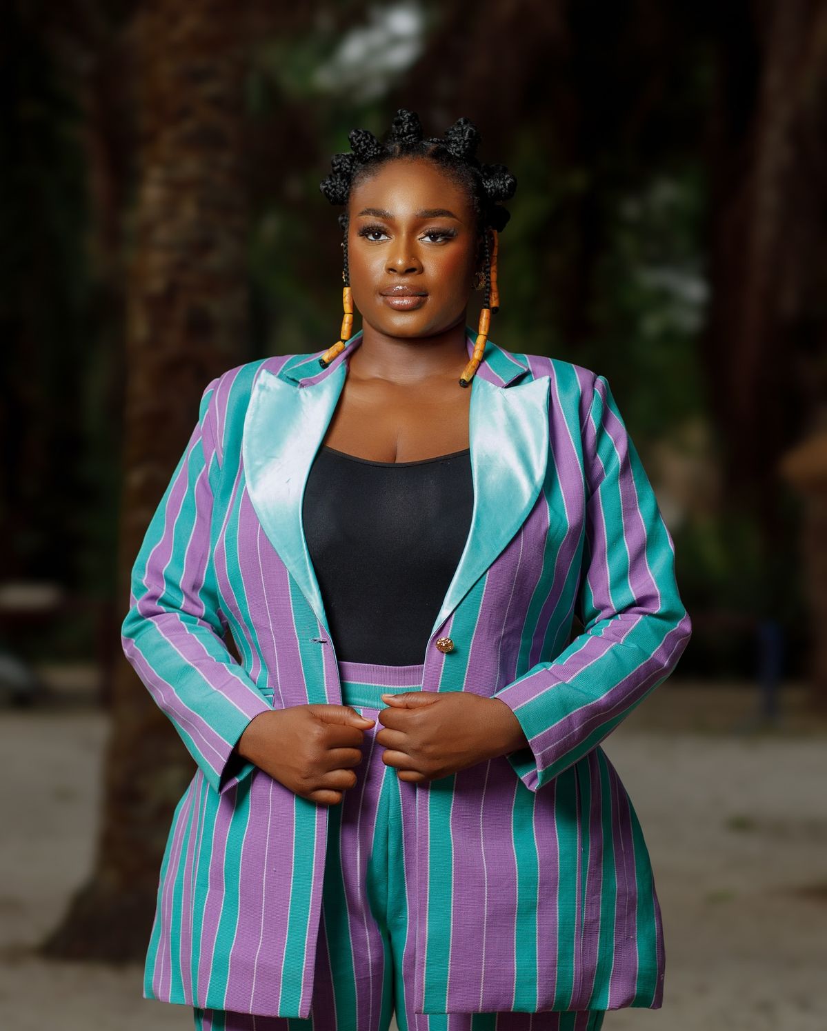 An inclusive woman in a high-end blazer, representing the visionary fusion of Adire heritage and modern luxury.