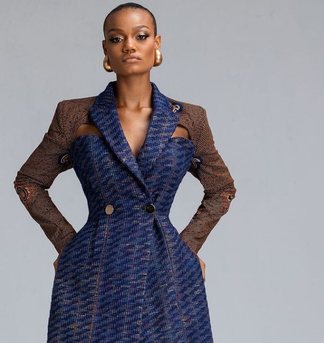 An inclusive woman practising high-end garment care for her blazer, representing the visionary fusion of luxury and architectural preservation.
