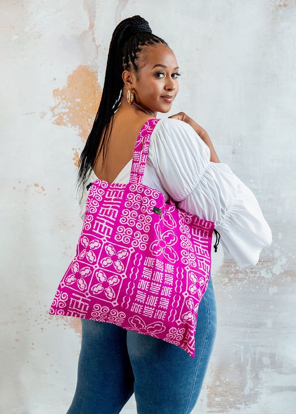 An inclusive woman practising high-end garment storage for her Aso-Oke blazer, representing the visionary fusion of luxury and structural preservation.
