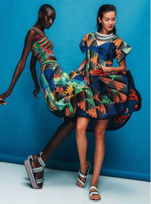 A picture of two women dressed in African clothing.