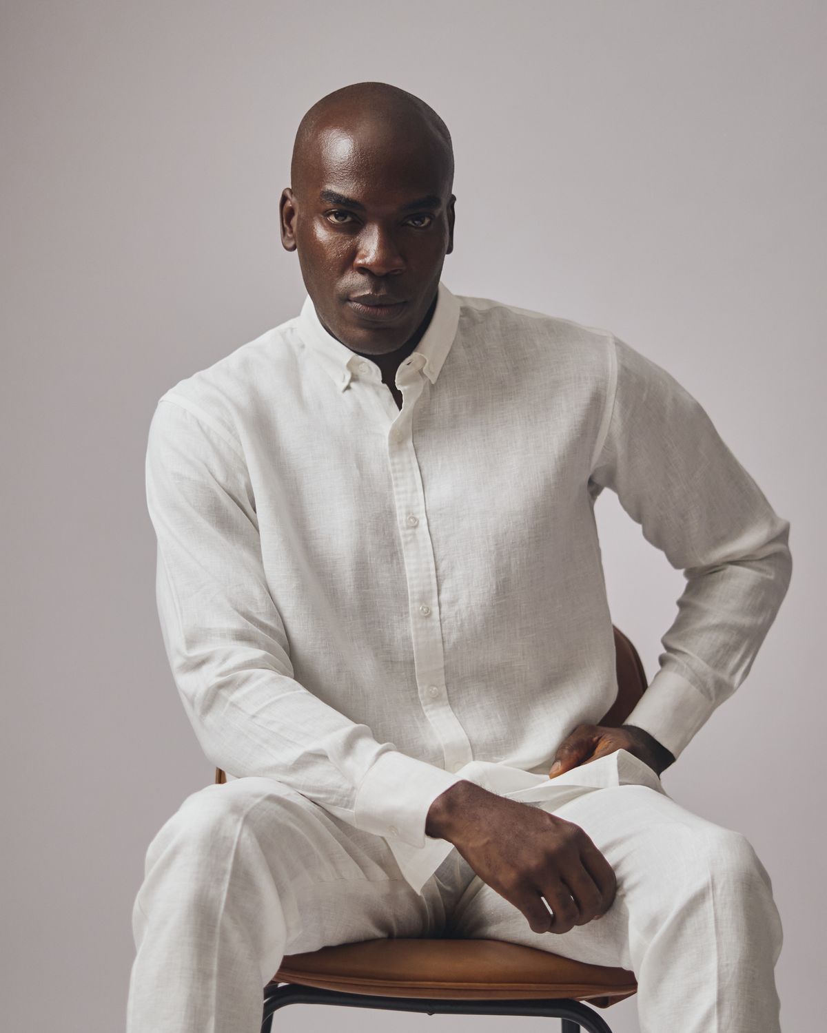 An inclusive man in a high-end hemp-blend shirt, representing the visionary fusion of circular stewardship and modern luxury.