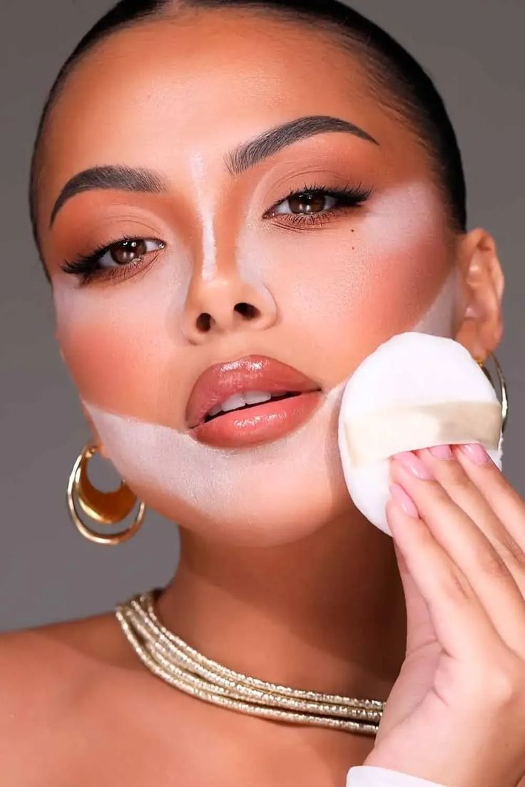 An image showing a lady using setting powder
