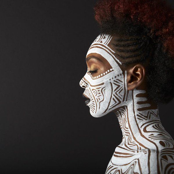 An image showing a guy with body painting inspired by African body painting traditions
