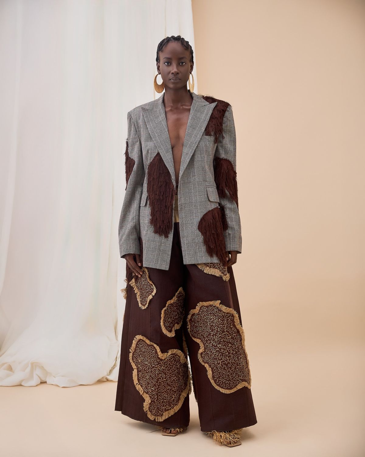 An inclusive woman in high-end, sustainable tailoring, representing the visionary fusion of heritage craftsmanship and modern luxury.