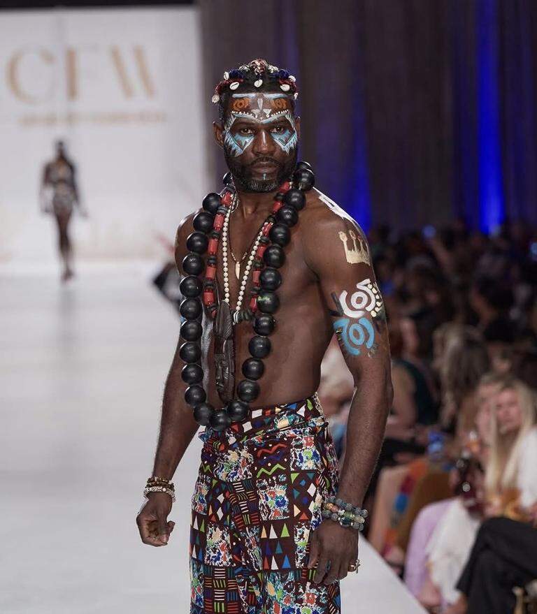 An image showing a man with body paint on a runway clearly showing the impact of African Body Paint Traditions in Runway Fashion

