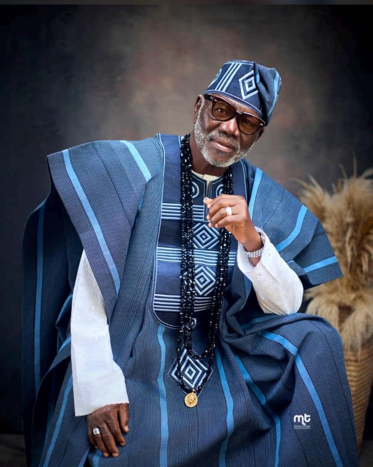 An inclusive man in a sustainable West African fila, representing the visionary fusion of architectural heritage and modern luxury. 