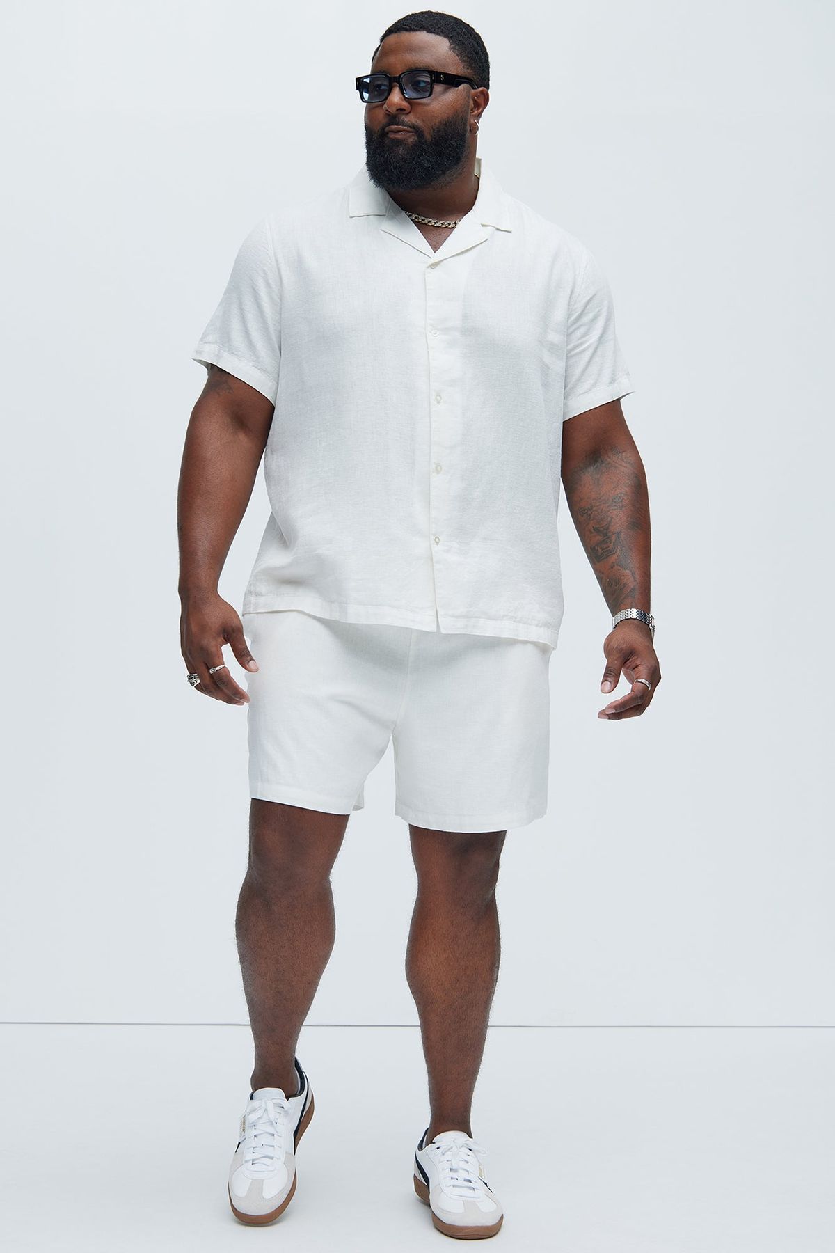 An inclusive man in a sustainable white organic cotton shirt, representing the visionary fusion of simplicity and modern luxury.