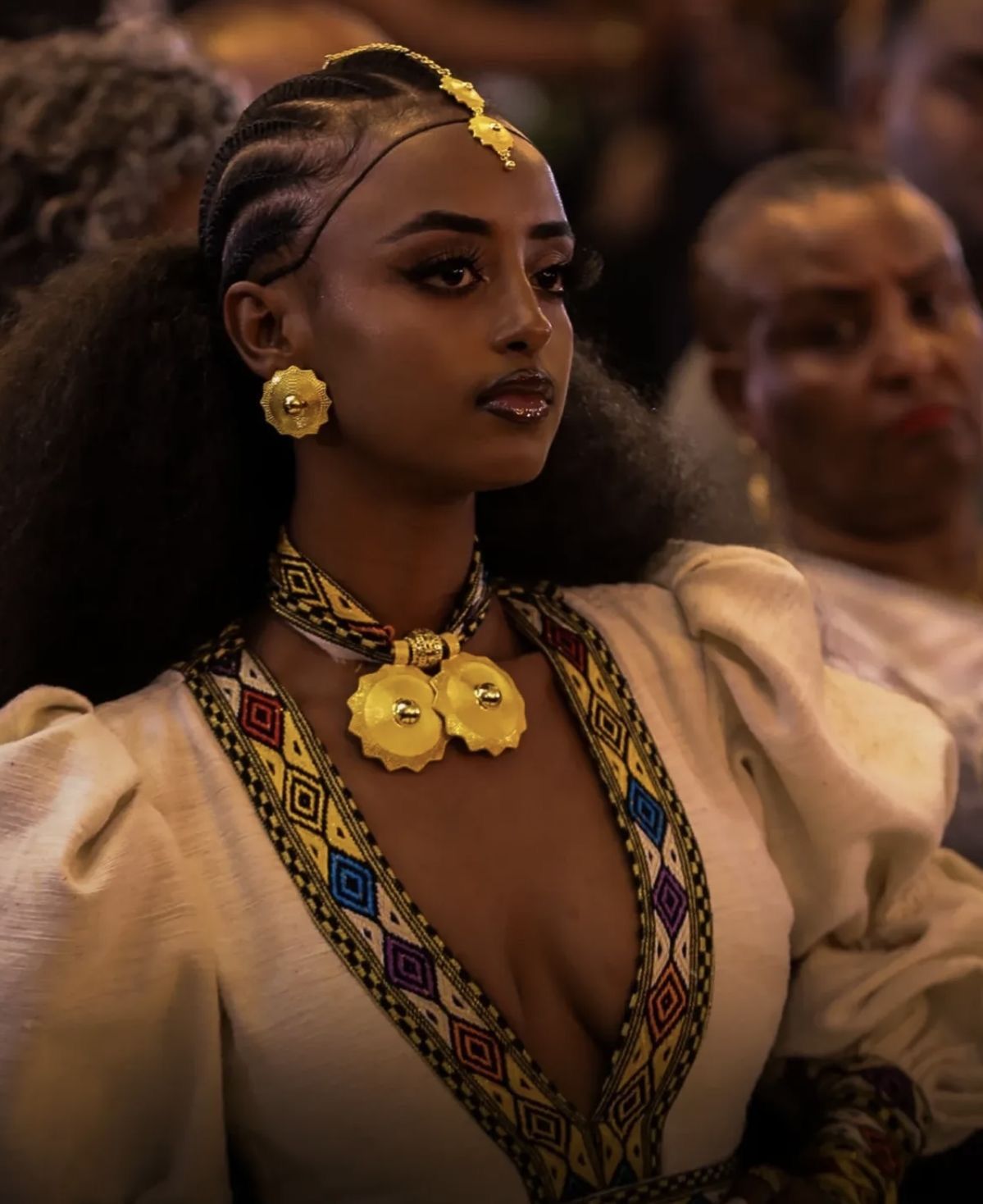 An inclusive woman in high-end tailoring, representing the visionary fusion of Ethiopian weaving and modern luxury.