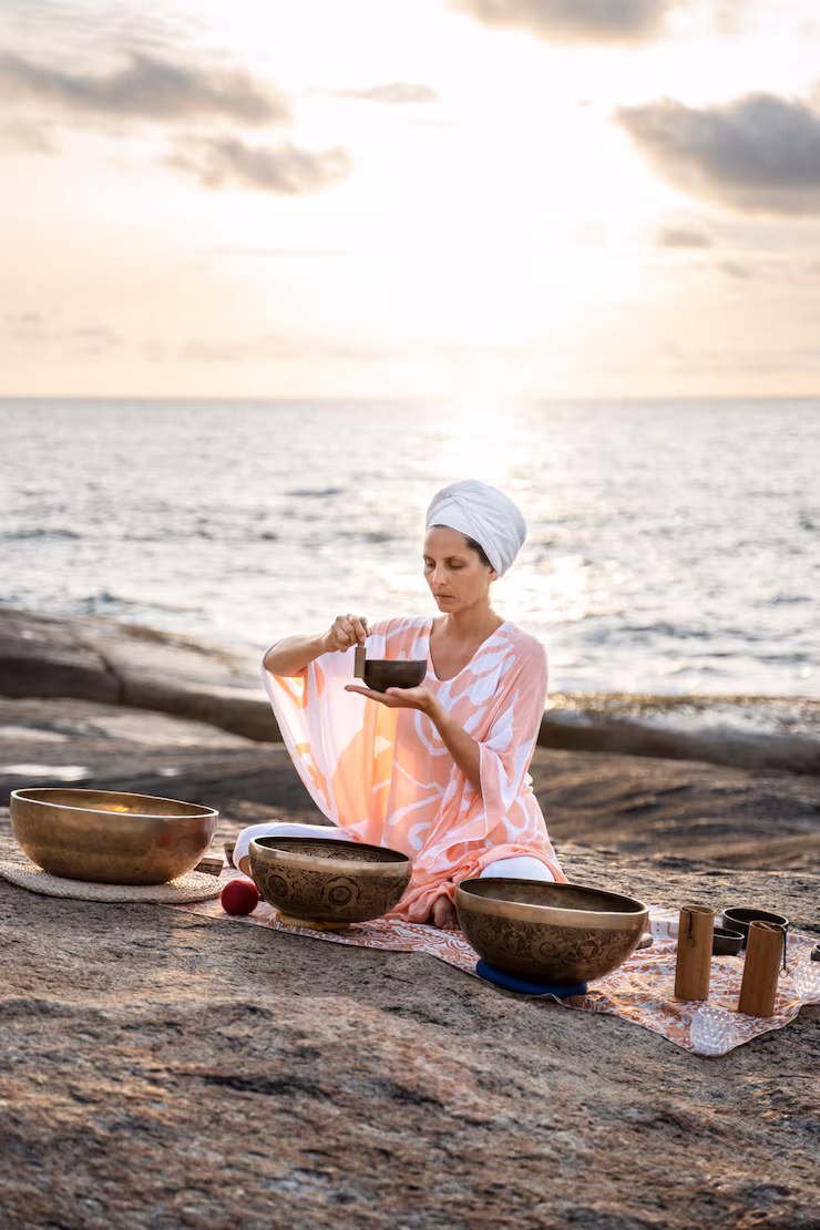 An image showing a lady sitting by the riverside and making products for Caribbean beauty rituals