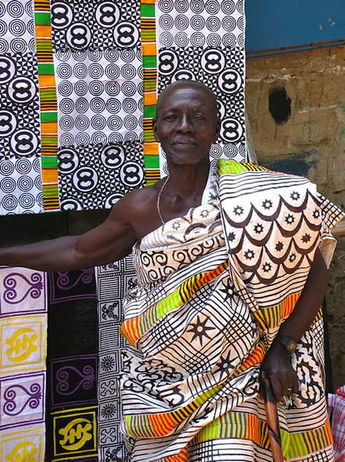 n image showing an older man wearing Adinkra fabric, one of the traditional clothing styles in Ghana