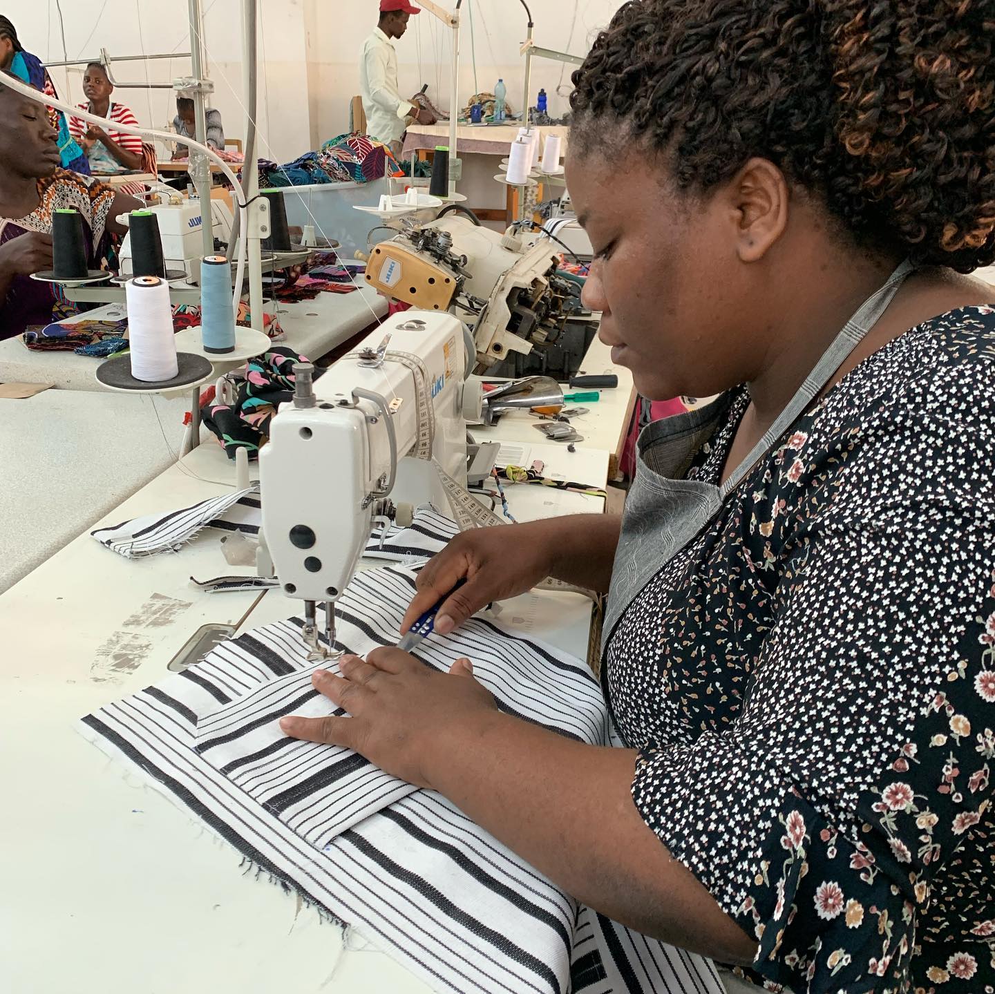An image showing some fashion designers tailoring in a shop in Dakar
