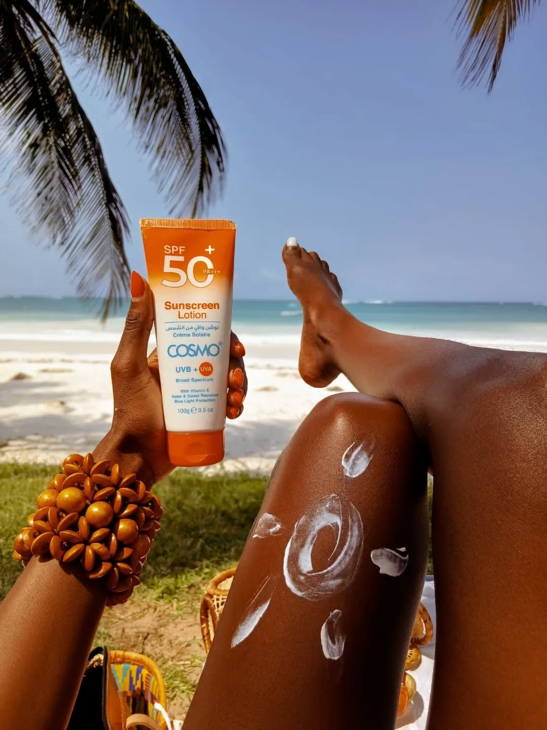 Correct sunscreen layering method on dark skin, showing even application without a white cast
