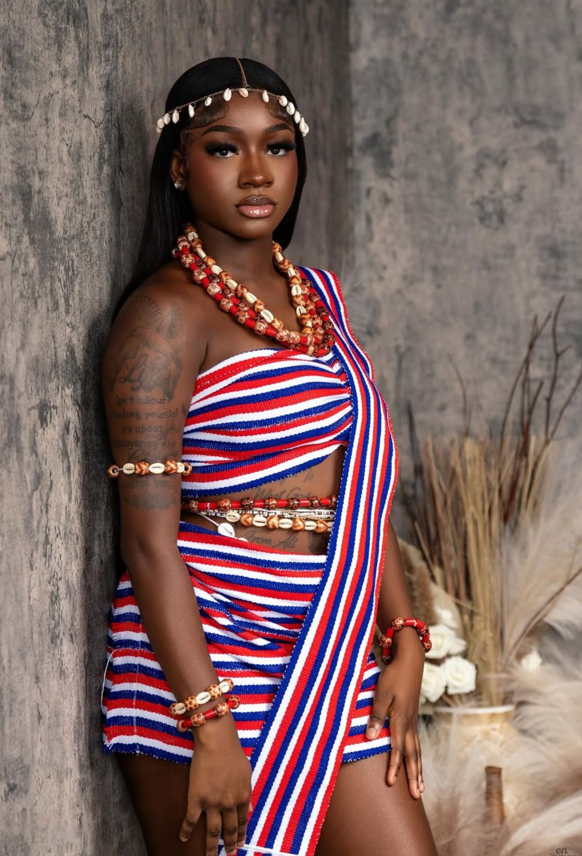 A Liberian woman wearing a ceremonial dress showing cultural identity.
