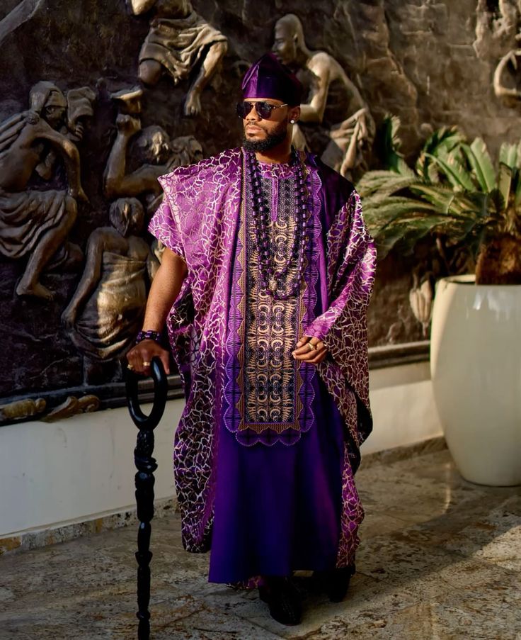 The Agbada: Seven Centuries of Considered Construction
The agbada, the wide-sleeved prestige robe of Yoruba men, is documented in the dress traditions of the twelfth- and thirteenth-century Mali and Songhai empires, where the nobility adopted it as a symbol of rank and religious authority. Arab geographer Al-Bakri, writing in 1068, recorded elaborate robes as part of the court dress of the Ghana Empire. Ibn Battuta’s fourteenth-century accounts of Mali under Mansa Musa describe court dress of considerable sophistication. These are not secondary sources. They are contemporary records from trained observers, written when the tailoring traditions around Cork Street in London were still centuries away from existing.

The Yoruba agbada is a three-piece ensemble: the outer robe, known as the fila, the buba inner tunic, and the sokoto drawstring trousers, all cut from the same fabric and embroidered at the chest in the juba pattern whose density and intricacy communicate the wearer’s investment and social standing. The embroidery at the chest opening is hand-stitched, requiring specialist knowledge and significant labour. The outer robe is cut wide enough that the sleeves must be folded back over the forearm when in motion: a construction decision that privileges the silhouette and the ceremony of arrival over ease of movement. This is not casual dress adapted for special occasions. It is a prestige garment system designed from the ground up for considered, occasion-specific wear.

“The agbada was documented in the courts of the Mali Empire in the twelfth century. Savile Row opened for business in 1803. The chronology is not a debate.”

The Babban Riga: The Hausa Tradition of the North

Pc: Pinterest
The babban riga, meaning 'large gown' in Hausa, is the prestige menswear tradition of the Hausa and Fulani peoples of northern Nigeria and the wider West African savannah. Like the agbada, it belongs to the family of wide-sleeved, embroidered over-robes that spread through West Africa via trans-Saharan trade routes and were adopted across the Sahel as markers of Islamic scholarship, political authority, and social standing. The babban riga’s embroidery, concentrated at the chest in patterns known collectively as the laba style, is among the most technically demanding in the region, with thread densities that can require weeks of work from specialist embroiderers to complete a single garment.

The Hausa tailoring tradition, centred in Kano, is one of West Africa’s oldest craft economies. Kano’s dyeing pits, some of which have been in continuous operation for over five centuries, supplied the indigo cloth that Hausa weavers and tailors worked into garments for trade networks stretching from the Sahara to the coast. The Emir of Kano’s court dress, the full babban riga in embroidered white or indigo, worn with a turban and matching trousers, represents a complete prestige menswear system whose protocols of fabric, embroidery pattern, and occasion-specific wearing conventions have been maintained without interruption across the same period in which European tailoring was still developing the concept of the fitted suit.
Aso-Oke: The Fabric That Makes the Man
The Yoruba aso-oke, meaning 'top cloth' in Yoruba, is a handwoven prestige textile produced on narrow horizontal strip looms by specialist weavers, historically concentrated in towns such as Iseyin and Ilorin in Oyo State. The cloth is woven in strips approximately four inches wide, which are then sewn together to produce the final fabric. Three distinct aso-oke weave types carry specific occasion associations: sanyan, a natural beige-brown woven from wild silk and cotton, is the most prestigious and is worn at funerals and title ceremonies; alaari, a deep red or magenta, is worn at high-status celebrations; etu, an indigo-dyed dark blue-black, is worn at formal ceremonies and chieftaincy events. Selecting the appropriate aso-oke type for the occasion is not optional. It is a social requirement whose breach communicates ignorance of the dress code.

The complete Yoruba men’s aso-oke ensemble for formal occasions includes the agbada outer robe in aso-oke, the buba tunic, the sokoto trousers, the fila cap shaped to match, and traditional beads at the wrist or neck. The ensemble is assembled months in advance of a major occasion, with the aso-oke commissioned specifically for the event and often colour-coordinated across family groups as aso-ebi, meaning 'family cloth', a practice that transforms individual dress into collective identity marking. The logistics of this system, the commissioning, the weaving, the cutting, the stitching, and the collective coordination are those of a sophisticated fashion infrastructure that requires no external reference point to legitimise it.

“The correct Aso-oke type for the correct occasion is a social requirement. Getting it wrong does not signal informality. It signals ignorance of the code. That is the standard of a dress tradition that knows exactly what it is.”

What Bespoke Actually Means in West Africa

Pc: Pinterest 
Savile Row’s claim to the word bespoke rests on the practice of cloth being spoken for by a specific client, cut to a pattern drafted exclusively for one body. That practice is precisely what the specialist tailors of West Africa have always done. The agbada is not purchased off a rack. It is commissioned from a tailor who knows the client’s body, the occasion for which it will be worn, the fabric the client has selected or had woven, and the embroidery pattern appropriate to the wearer’s status and the event’s formality. The measurement, the cutting, the hand-finishing, and the embroidery are all performed by skilled practitioners whose knowledge is transmitted through apprenticeship. The finished garment belongs to one person and was made for one occasion. That is bespoke. The word did not originate in West Africa, but the practice did, centuries before it had an English name.

The tailors who produce these garments, the Asa-oke weavers of Iseyin, the agbada embroiderers of Abeokuta and Ibadan, and the babban riga specialists of Kano, represent an artisanal workforce of considerable skill and cultural knowledge. Their practices are transmitted through apprenticeship systems that can last several years and that require demonstrable competency before a practitioner is considered qualified to produce prestigious garments independently. The training model is not dissimilar to the apprenticeship tradition at Savile Row. The West African version predates it by several centuries.
Ozwald Boateng and What Happened When Africa Walked Into the Row
In 1995, Ozwald Boateng became the first tailor of African heritage to open a house on Savile Row itself. Born in London to Ghanaian parents, Boateng brought a design philosophy shaped by his father’s Ghanaian kente and the cultural confidence of a man who grew up understanding African prestigious dress as the baseline, not an aspiration. His suits, which brought colour, drama, and a theatrical approach to silhouette to a street defined by conservative restraint, were not departures from the Savile Row tradition. They were a return to a more fundamental truth about prestige menswear: that it should announce presence, communicate status, and reward the occasion that demands it. That is what the agbada has always done. Boateng made it legible to an institution that had been built without reference to the tradition it was echoing.
Boateng’s success on Savile Row, his appointment as creative director of Givenchy Homme in 2003, and his subsequent work documenting African fashion through the documentary series A Man’s Story, constitute one of the most direct arguments ever made about the relationship between African dress tradition and global menswear. He did not enter Savile Row as an outsider bringing an unfamiliar aesthetic. He entered it as a man whose aesthetic roots were in a tailoring tradition older than the street, and the Row was permanently changed by his presence.
The Chronological Record Deserves to Be Stated Plainly
West African prestige menswear was documented by Arab geographers in the eleventh century. The nobility of the twelfth and thirteenth-century Mali Empire wore embroidered over-robes as markers of rank. The Hausa babban riga tradition in Kano was established alongside dyeing and weaving industries that have been continuously operational for five centuries. The Yoruba aso-oke weaving tradition produces occasion-specific prestige cloth whose wearing conventions are socially enforced. The agbada is a three-piece, hand-embroidered, client-specific prestige ensemble whose construction requires specialist knowledge accumulated through years of apprenticeship. Savile Row began accepting tailoring workshops in approximately 1790. Henry Poole opened at number 32 in 1846.

The global fashion industry’s habit of positioning Savile Row as the origin point of considered menswear is not a neutral historical error. It is the product of a centuries-long alignment between Eurocentric assumptions about craft, sophistication, and cultural authority, and the editorial infrastructure of an industry that has consistently located those qualities in Western Europe. West African tailoring does not need to be measured against Savile Row to establish its significance. It preceded it. The significance was always there. The documentation simply has not been written in the places where the global fashion press has been looking.

Read next: 
Agbada Boubou, Grand Boubou: One Silhouette, Four Countries, Four Arguments About Power
OMIREN ARGUMENT
Pc: Pinterest 
The standard account of global menswear history positions the European fitted suit and Savile Row bespoke tailoring as the apex from which other dress traditions are measured. West African prestige menswear predates that apex by approximately seven hundred years, operates from a complete set of occasion-specific wearing conventions, requires specialist artisanal knowledge transmitted through structured apprenticeship, and produces garments cut and constructed for individual clients. Every criterion the global fashion industry uses to define serious tailoring applies to the agbada, the babban riga, and the aso-oke ensemble. The only criterion that does not apply is location. These traditions were built in Kano, in Ibadan, in Abeokuta, in Iseyin, not in Mayfair. That is the structural reason they have not been given the critical literature they merit. The chronological argument this article makes is not revisionist. It is the record, read in full, without the assumption that European tailoring was the centre from which everything else radiated.
Frequently Asked Questions
What is the history of West African menswear?
West African menswear has a documented history extending to the eleventh century, when Arab geographers recorded prestige robes at the courts of the Ghana Empire. The agbada-type flowing over-robe was adopted by the nobility of the twelfth- and thirteenth-century Mali and Songhai empires as a marker of rank and religious authority. The Hausa babban riga tradition in Kano developed alongside dyeing and weaving industries that have operated continuously for over five centuries. The Yoruba aso-oke weaving tradition produces occasion-specific prestige cloth whose wearing conventions are socially codified. These are among the oldest documented menswear traditions in the world.
What is an agbada, and how is it constructed?
The agbada is a three-piece prestige ensemble worn by Yoruba men across West Africa, consisting of an outer robe with wide sleeves, a fitted buba inner tunic, and matching sokoto drawstring trousers. All three pieces are cut from the same fabric. The outer robe features hand-embroidered decoration at the chest opening, known as the 'juba', whose density and pattern communicate the wearer’s status and the occasion’s formality. Fabric choices range from hand-woven aso-oke in prestige weave types to imported brocade and Swiss voile. The garment is commissioned from specialist tailors and constructed for specific occasions.
How does West African tailoring compare to Savile Row?
West African tailoring predates Savile Row by approximately seven hundred years. Savile Row as a tailoring destination dates from approximately 1790, with the first tailors taking premises on the street itself by 1803. West African prestige menswear was documented by Arab geographers in the eleventh century and established as a sophisticated court-dress tradition in the twelfth- and thirteenth-century Mali and Songhai Empires. Both traditions involve client-specific commissioning, specialist artisanal knowledge transmitted through apprenticeship, and occasion-specific wearing conventions. The primary difference is that one tradition has been accorded critical literature and institutional recognition proportionate to its age and sophistication. The other has not.
What is aso-oke fabric, and how is it used in men's dress?
Aso-oke is a hand-woven prestige textile produced by specialist Yoruba weavers on narrow horizontal strip looms, historically concentrated in towns including Iseyin and Ilorin in Oyo State, Nigeria. It is woven in four-inch strips that are sewn together into finished cloth. Three primary weave types carry specific occasion associations: sanyan, a natural beige-brown from wild silk and cotton, is the most prestigious and is worn at funerals and title ceremonies; alaari, a deep red or magenta, is worn at high-status celebrations; and etu, an indigo dark blue-black, is worn at formal ceremonies and chieftaincy events. Selecting the correct type for the correct occasion is a socially enforced requirement.
Who is Ozwald Boateng, and what is his significance in menswear history?
Ozwald Boateng is a British-Ghanaian tailor who, in 1995, became the first person of African heritage to open a tailoring house on Savile Row itself. Born in London to Ghanaian parents, he brought a design philosophy influenced by his father’s Ghanaian kente and the visual confidence of African prestige dress. His collections introduced colour, drama, and theatrical silhouette to Savile Row, and he was appointed creative director of Givenchy Homme in 2003. He subsequently produced A Man’s Story, a documentary series examining the relationship between African dress tradition and global menswear. His presence permanently changed the aesthetic conversation on the Row.
