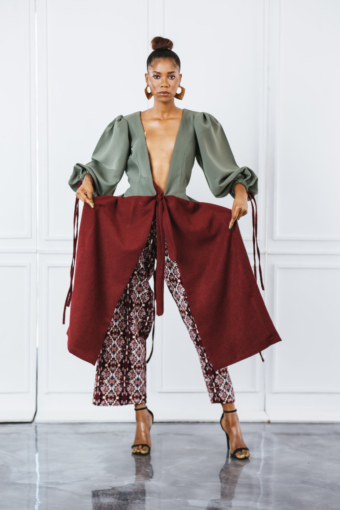 An image showing a lady dressed in Chocolate Clothing by Kwaku, one of Ghanaian fashion designers shaping Africa's global fashion narrative