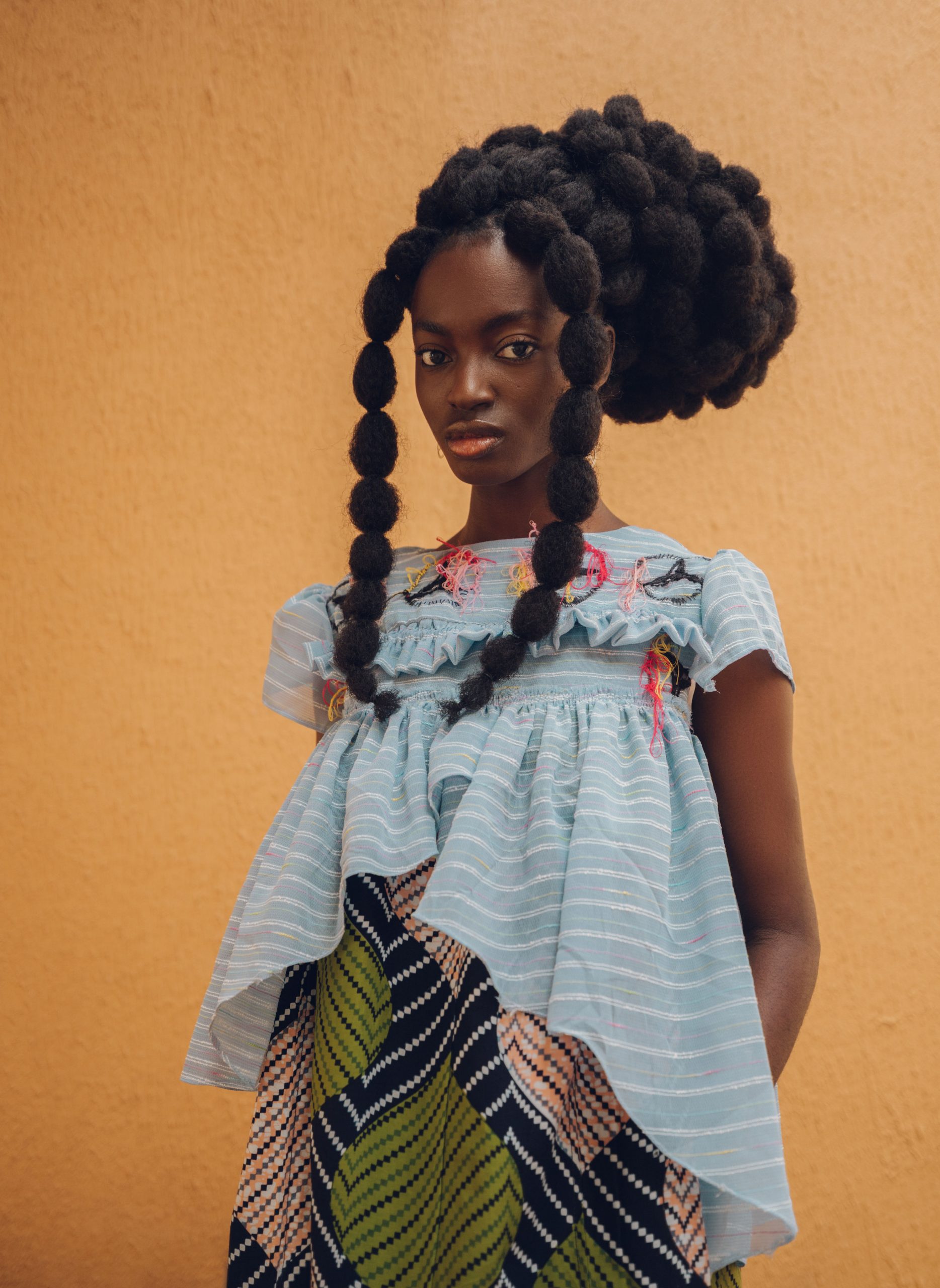 An image showing a lady wearing one of Chloe Asaam's works.
