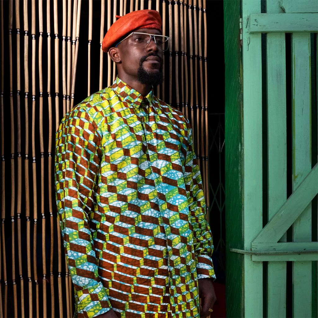  An image showing a dark man wearing a shirt made with wax print