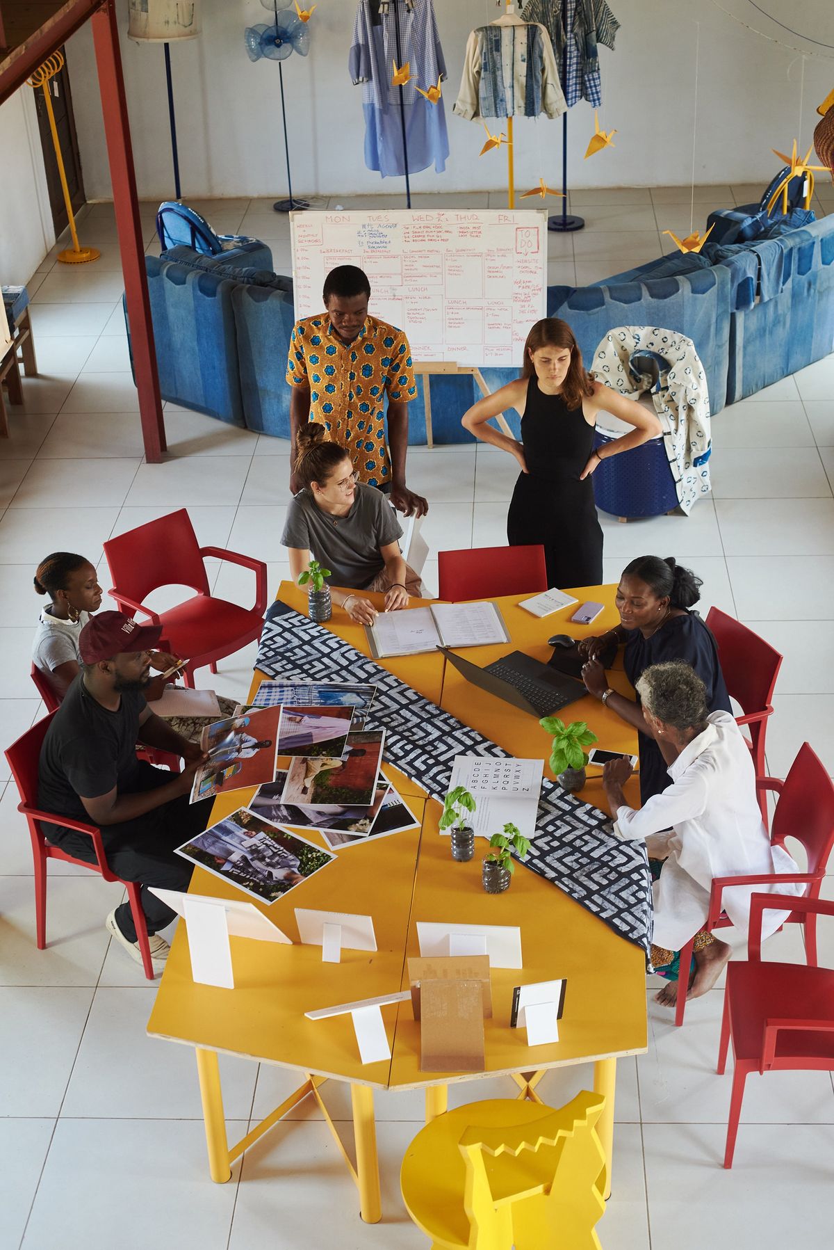 Burkinabè fashion entrepreneurs reviewing sustainable textile designs.