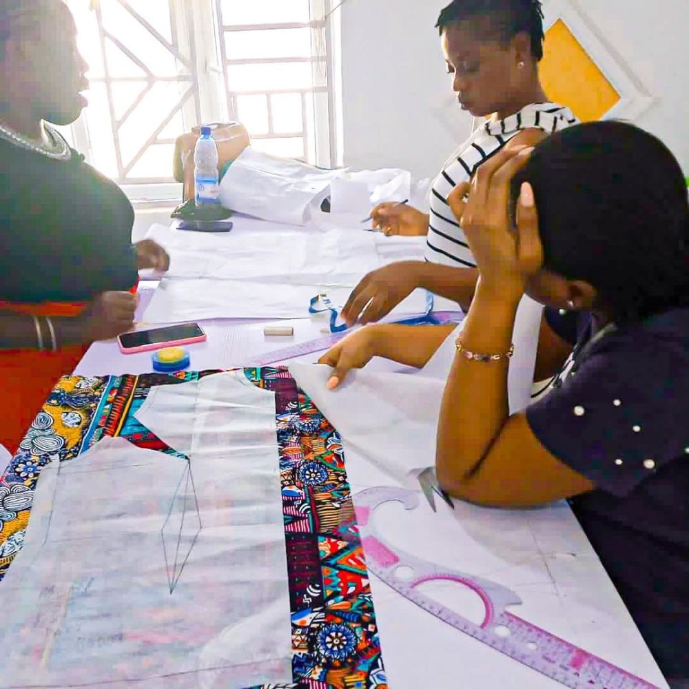 A Guinea-Bissau tailor working on sustainable custom fashion.
