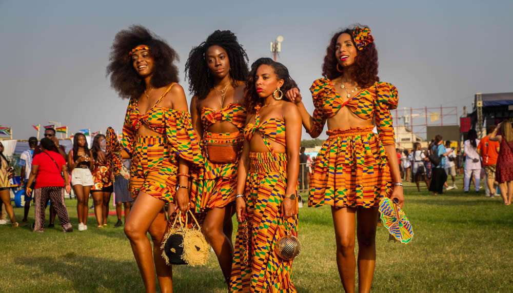 An image showing ladies wearing dresses made with kente