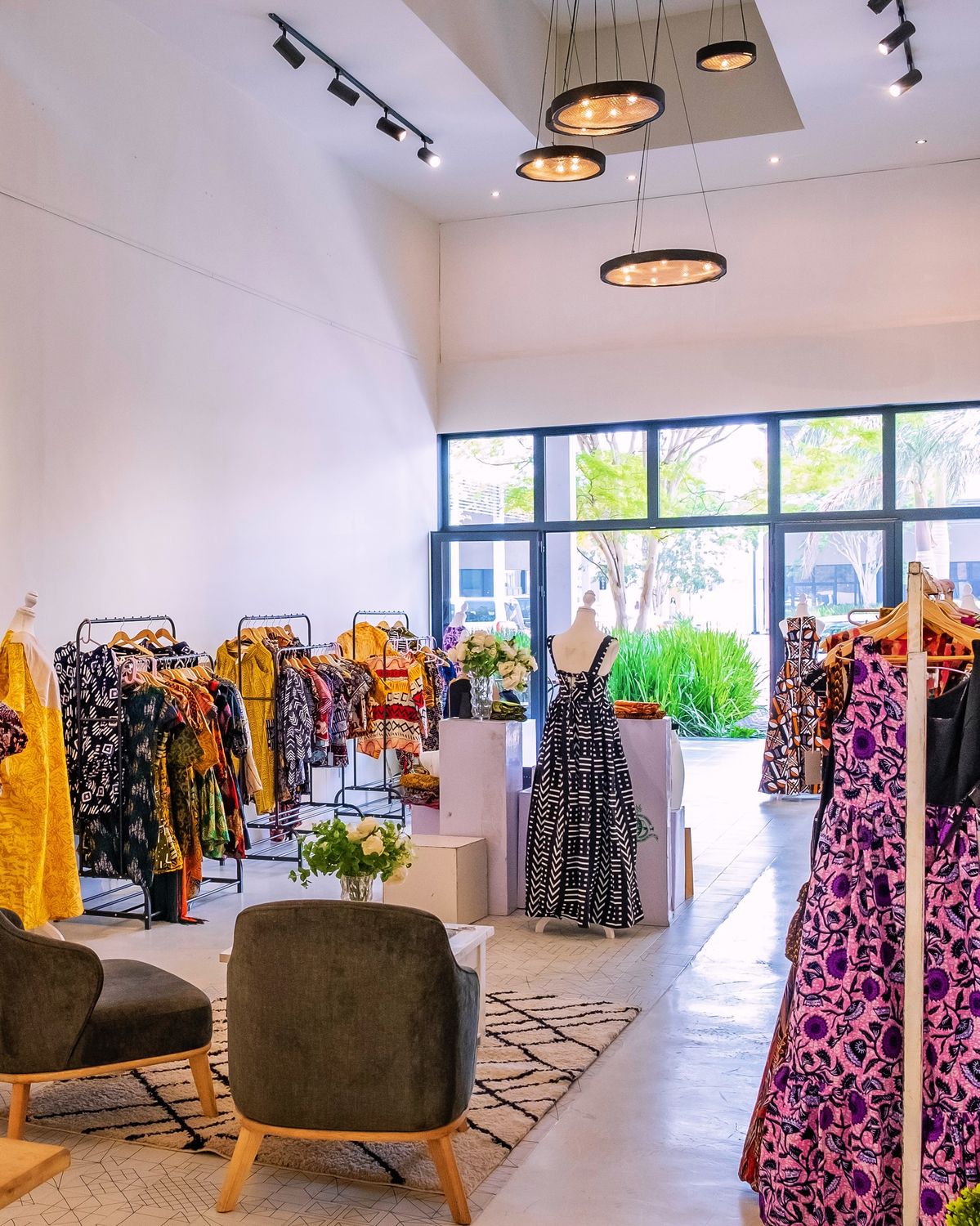 African fashion shoppers evaluating diaspora brand products in a premium retail setting