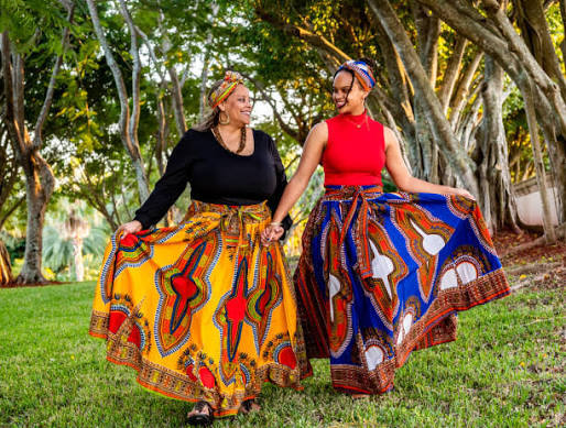An image showing a mother and doctor wearing a skirt made with one African traditional fabric