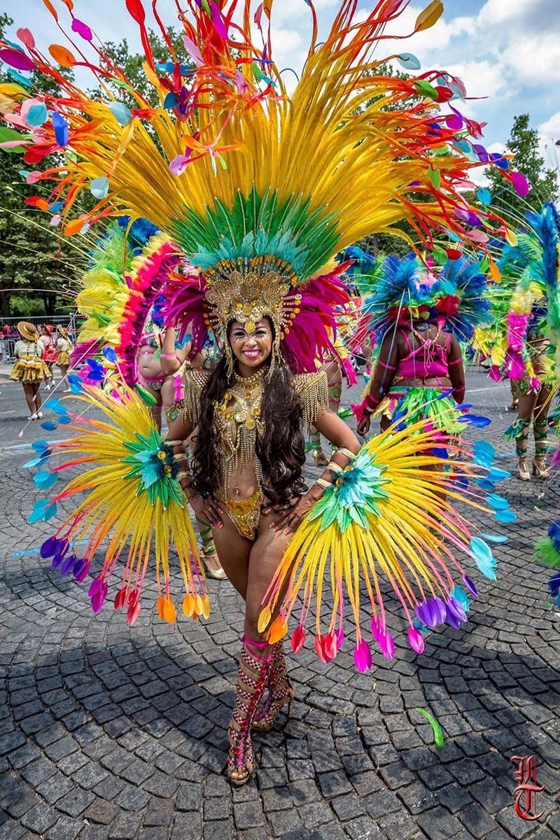 Dominican woman in award-winning recycled carnival costume made from plastic bottles and discarded materials.
