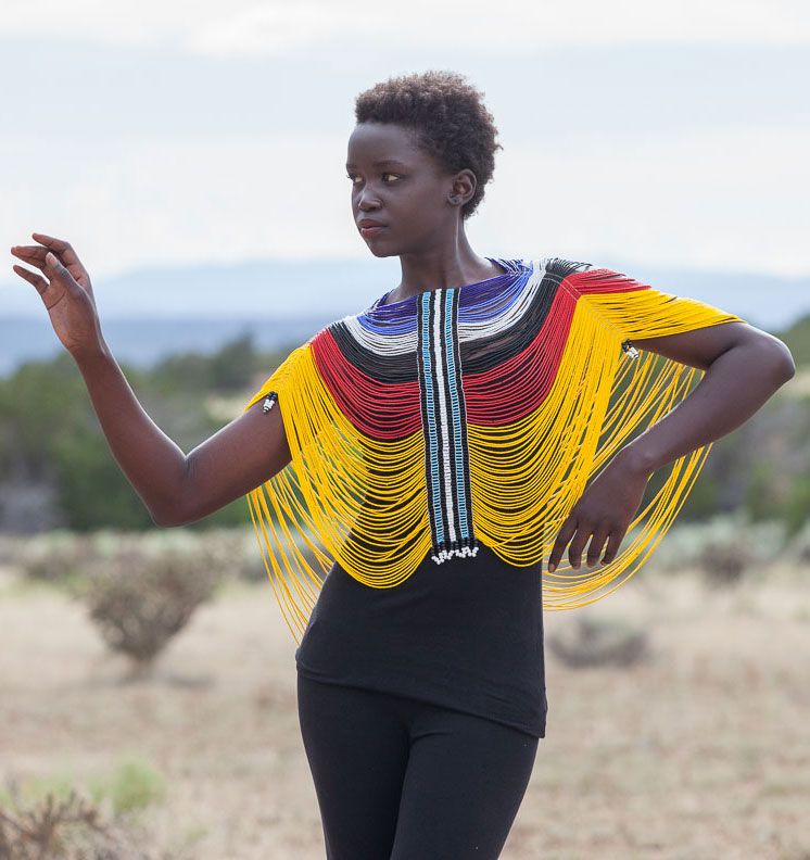 An image of a woman wearing a multicoloured Dinka beaded corset.