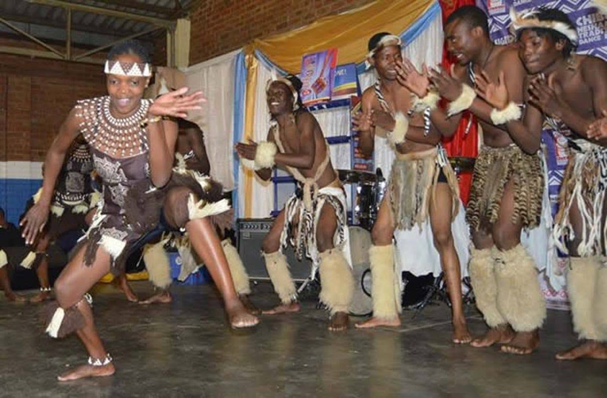 An image showing male Muchongoyo dancers in Ndau Men's ceremonial dress